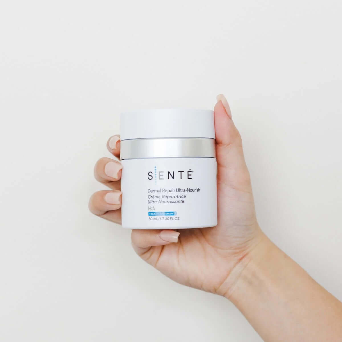 Senté Dermal Repair Ultra-Nourish jar held in hand for daily moisture, dryness relief, and calmer-looking skin.