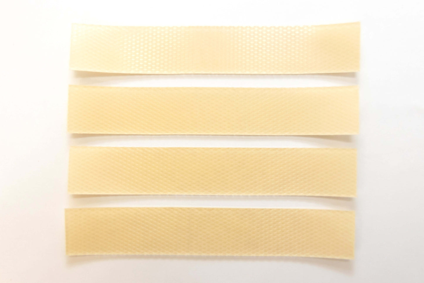 Silagen beige silicone scar strips laid out on white background, flexible silicone sheets for scar coverage and support.