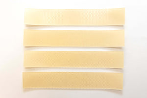 Silagen beige silicone scar strips laid out on white background, flexible silicone sheets for scar coverage and support.
