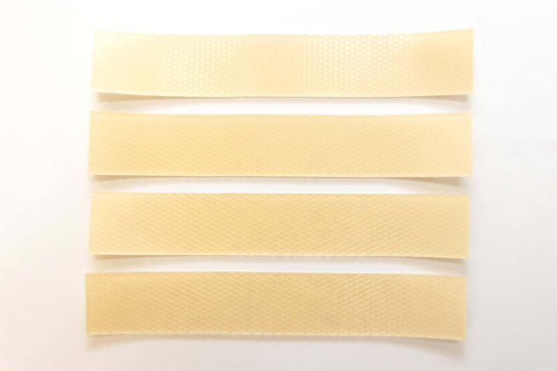 Silagen beige silicone scar strips laid out on white background, flexible silicone sheets for scar coverage and support.