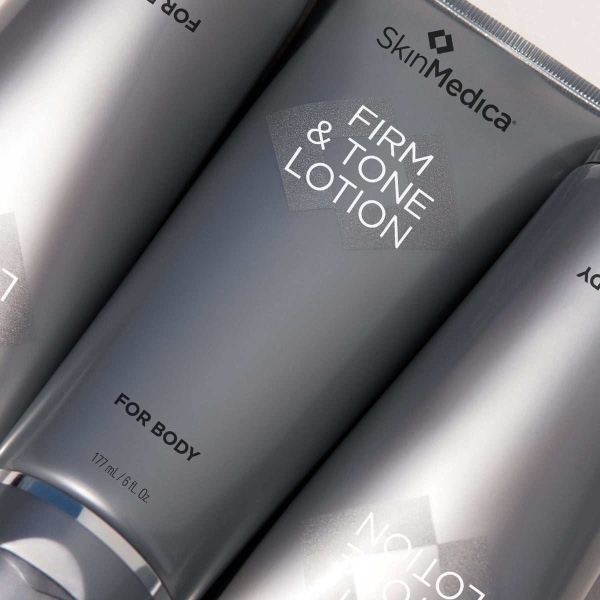 SkinMedica Firm & Tone Lotion tube close-up showing peptide body lotion with caffeine for crepey skin and texture care daily